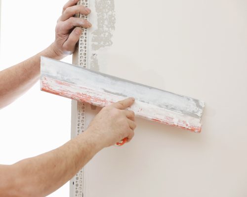 builder-in-protective-mask-using-a-trowel-to-add-p-XG98Y9H builder-in-protective-mask-using-a-trowel-to-add-p-XG98Y9H